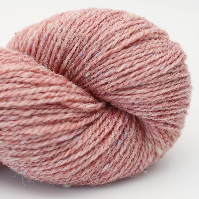 Skein of pink yarn with pastel coloured speckles Beara Irish wool and UK alpaca tweed dk, worsted or aran weight yarn by Hey Mama Wolf 