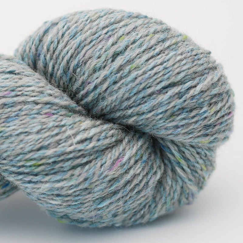 Close-up of a skein of blue and grey marled yarn Beara Irish wool and UK alpaca tweed dk, worsted or aran weight yarn by Hey Mama Wolf 