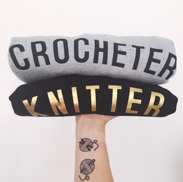 Stitchers Tees Unisex T-Shirt: Black Tee with Gold Lettering