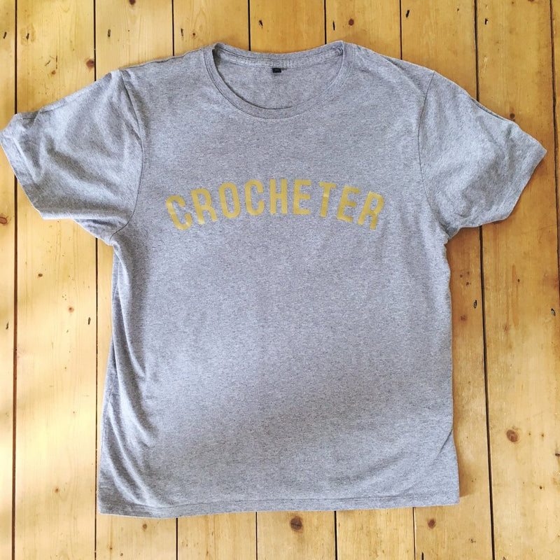 Stitchers Tees Unisex T-Shirt: Black Tee with Gold Lettering